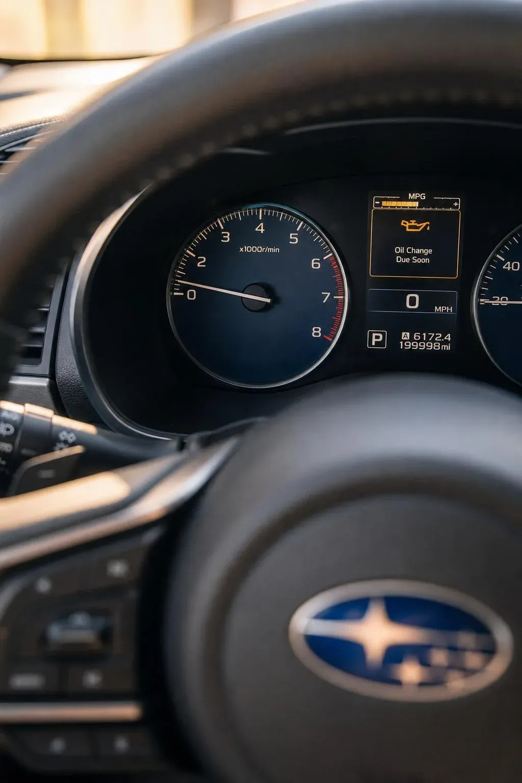 Subaru dashboard showing oil change reminder and high mileage
